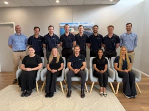 Hunter Rehabilitation and Health team of physiotherapists and exercise physiologists standing and sitting together in the clinic